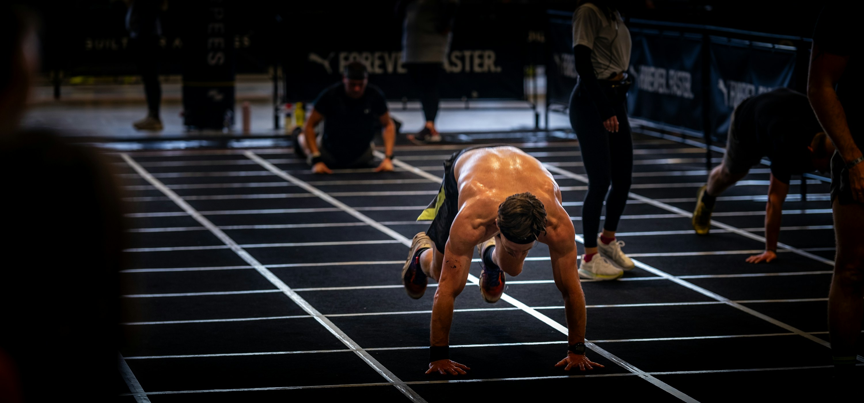 Sprinter in the starting blocks on a dark track