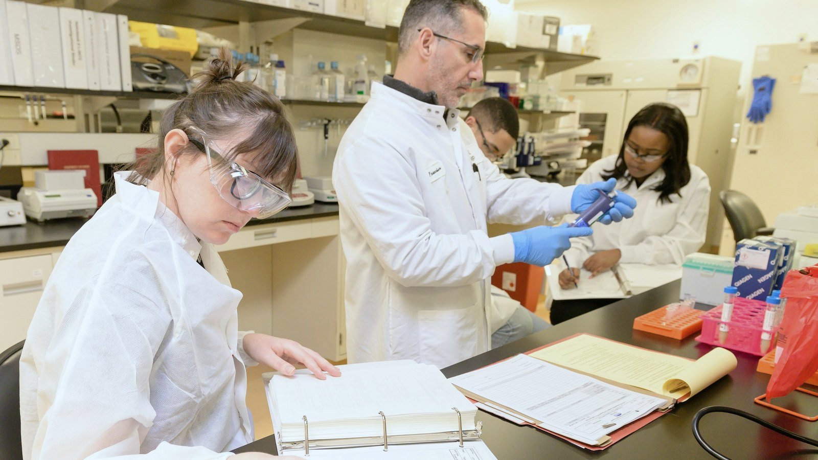 Scientists reviewing printed test results in a laboratory